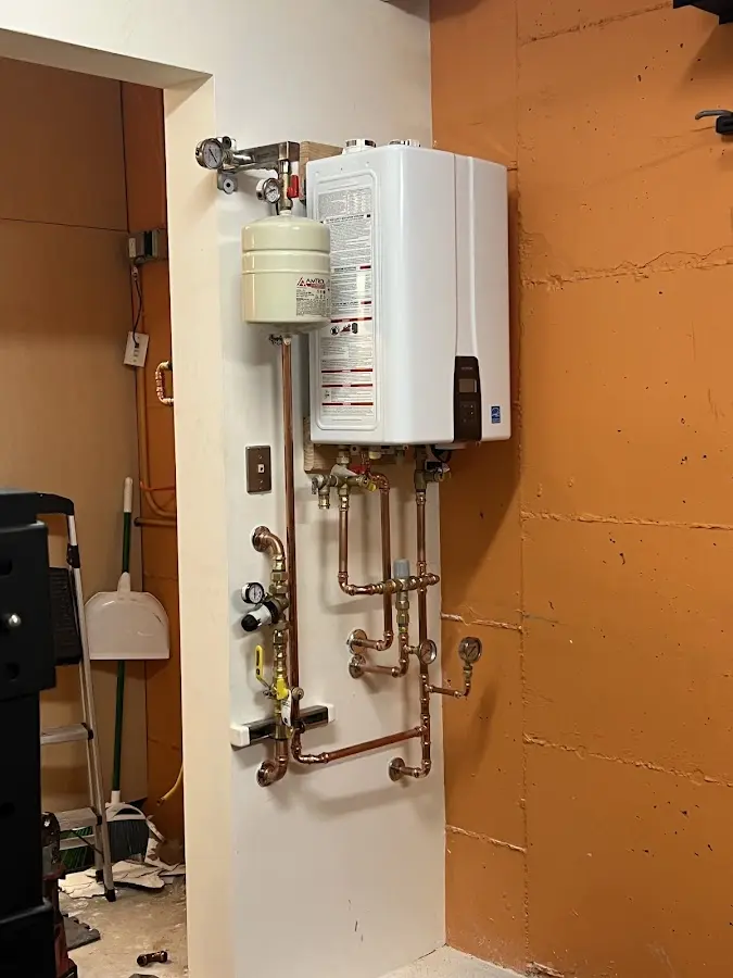 Plumbing technician inspecting water heater connections in Myrtle Creek